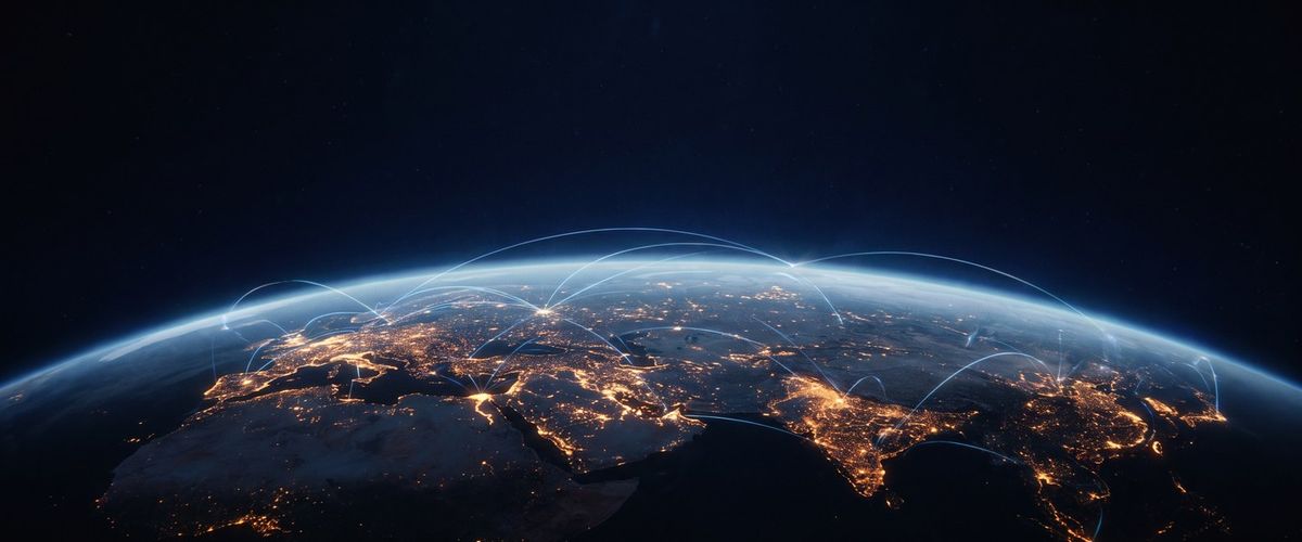 Earth at night from orbit, city lights tracing the continents