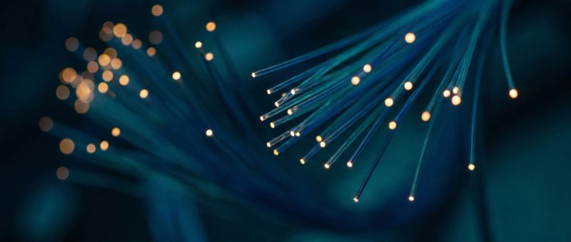A high-density AI compute cluster with glowing fibre-optic cabling