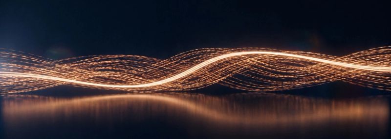 Braided streams of light across a dark reflective surface