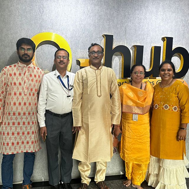 Inspira colleagues in traditional dress at a festive celebration in the office