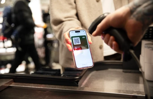 A digital ID card is scanned at checkout