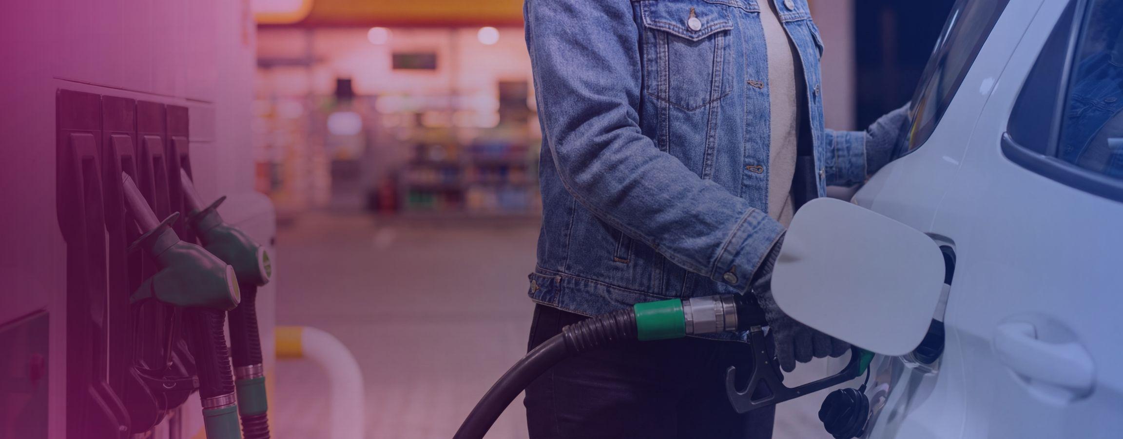 person filling up their car with fuel