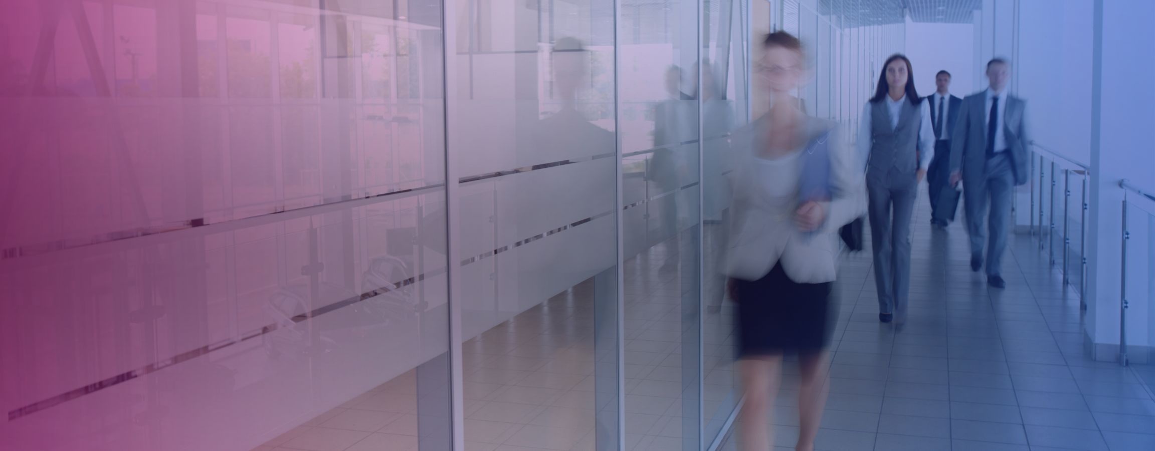 Stock image of employees walking through an office