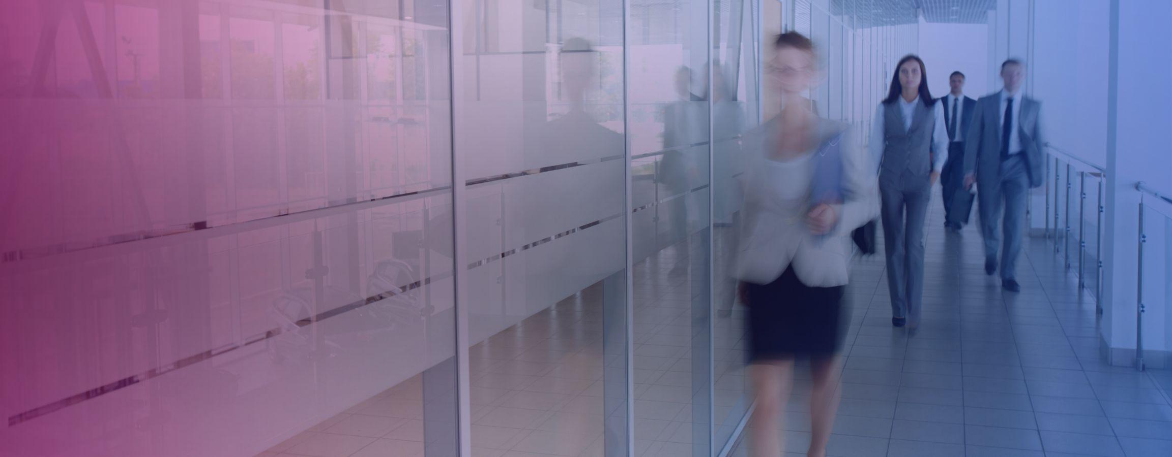 Stock image of employees walking through an office
