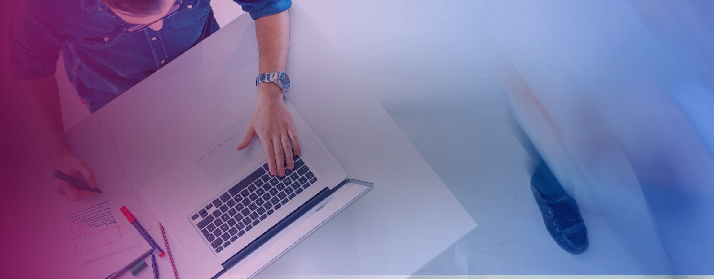 A birds eye angle of an employee working on their laptop