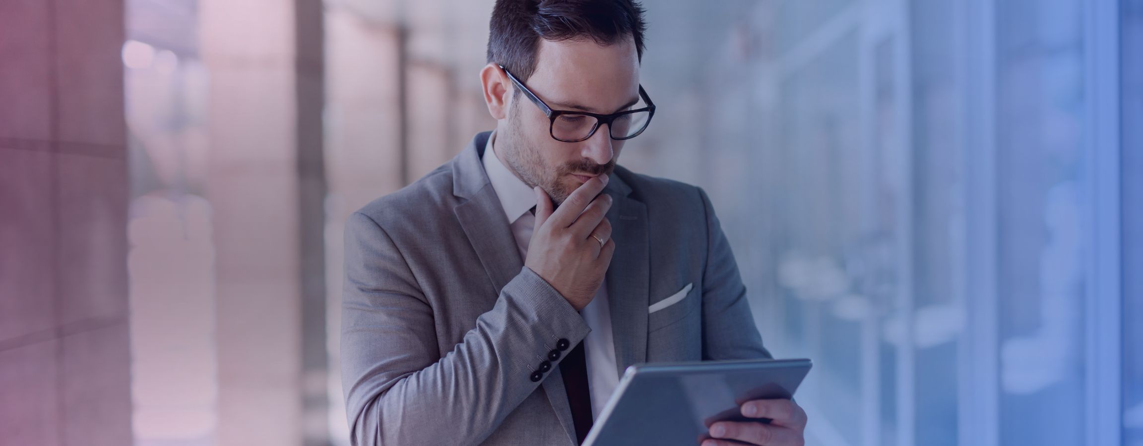 A businessman looking concerned at his electronic tablet