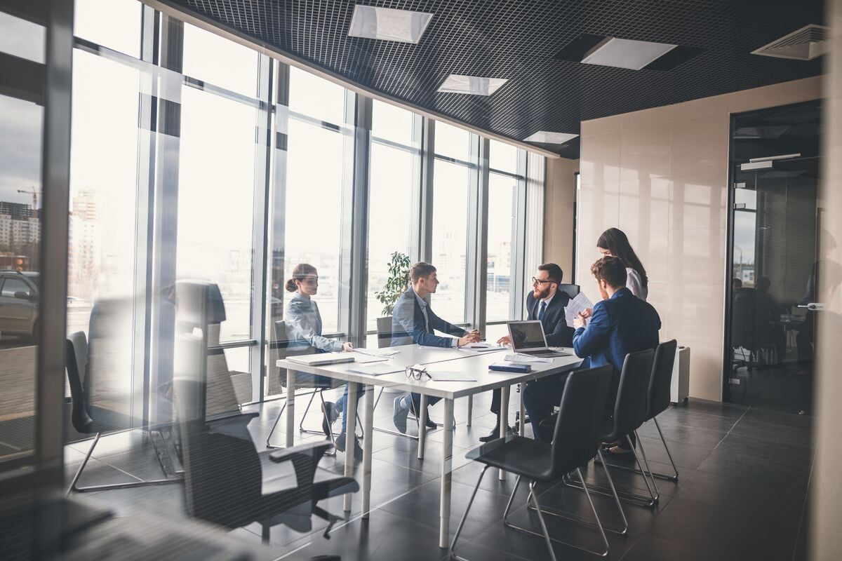Group of people around a table having a meeting
