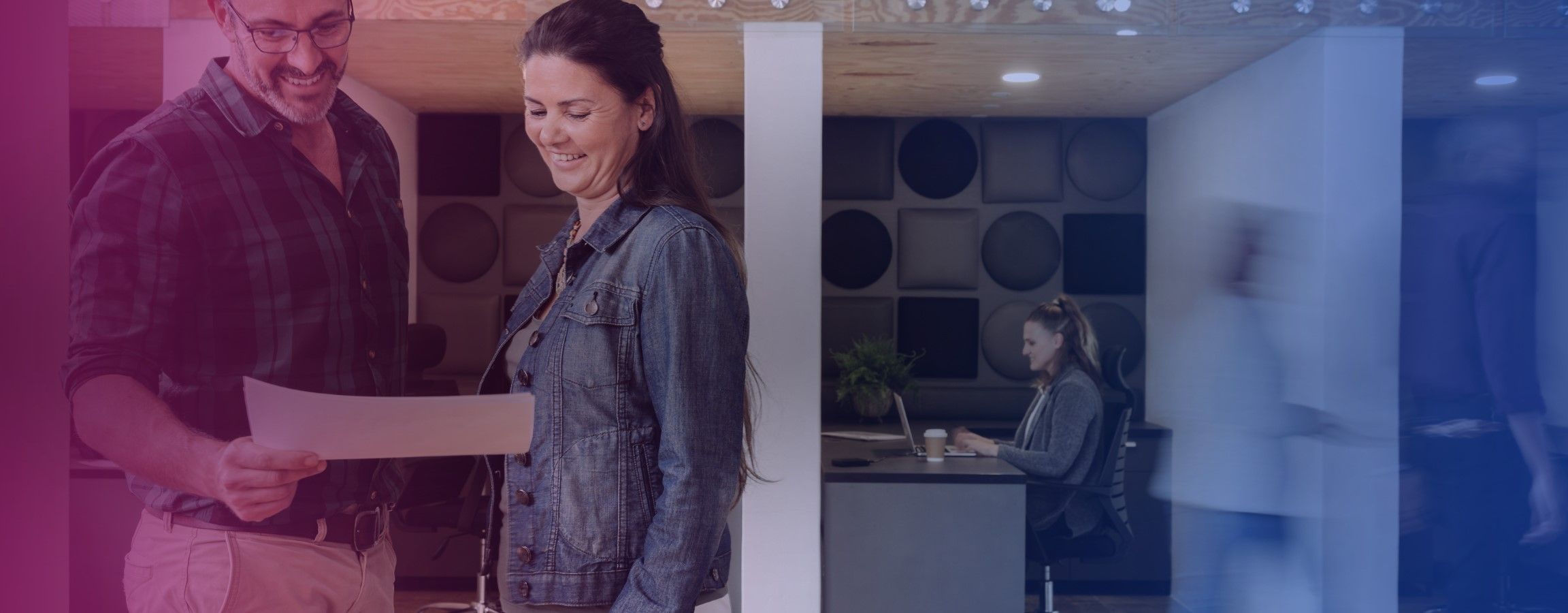 Office stock image with two employees looking at a document