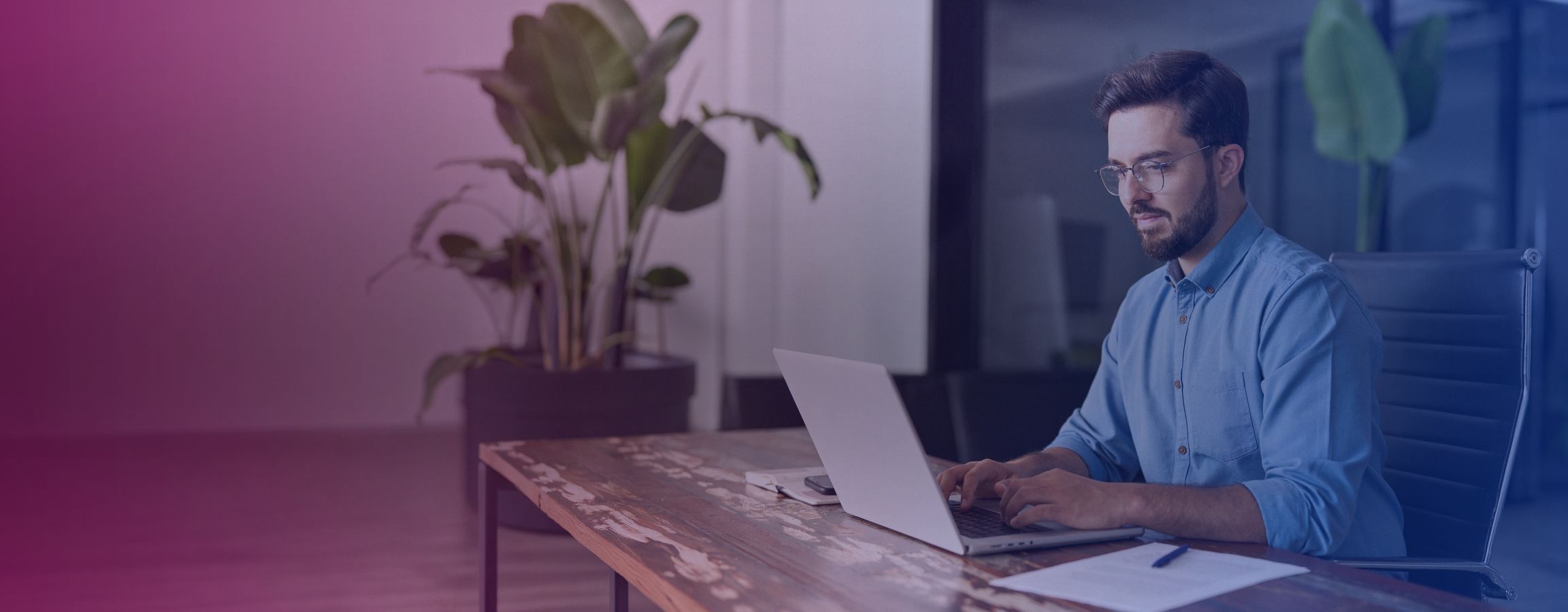 person working on their laptop at a desk