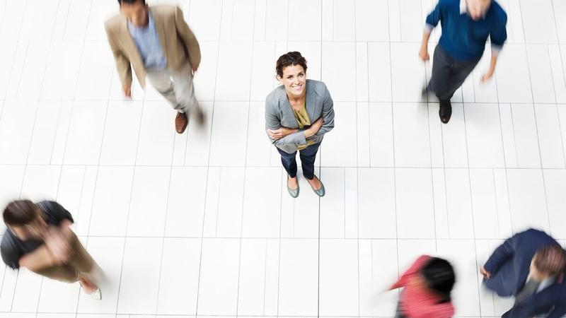 Woman looking up on a busy street