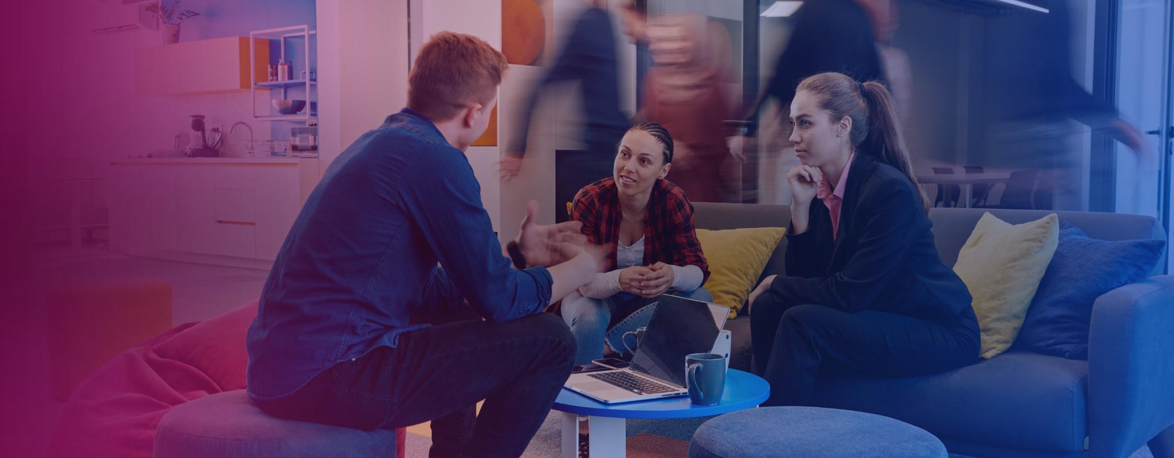 Office stock image, employees conversing at a table