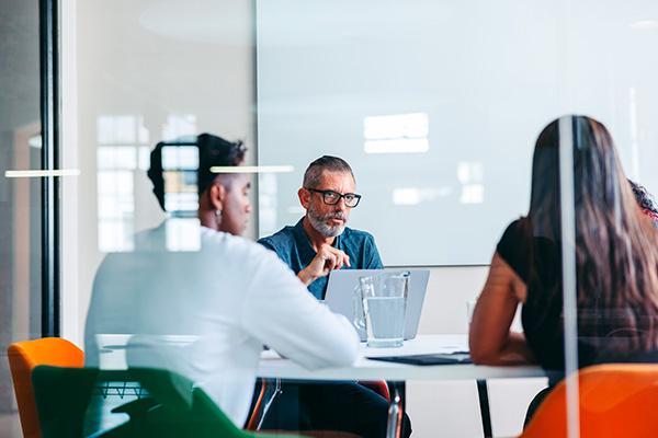 businessmeeting with three people around a table