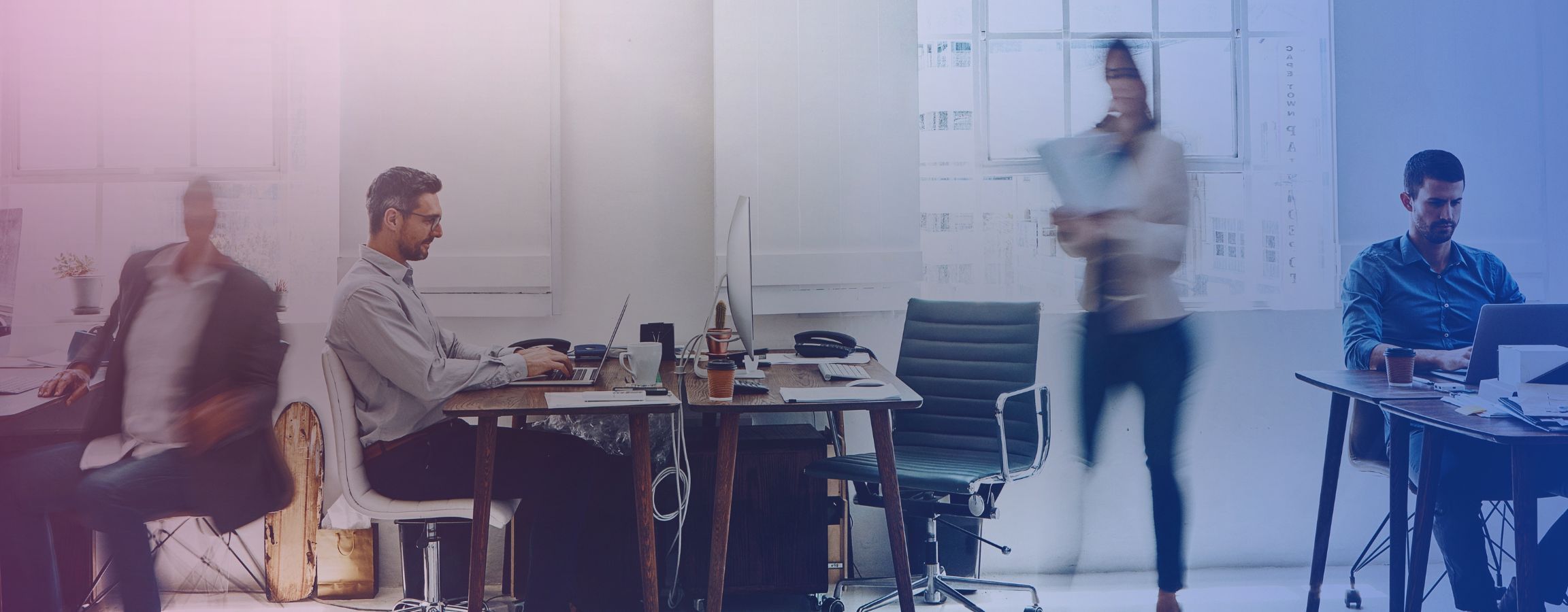 Stock image of employees working in an office