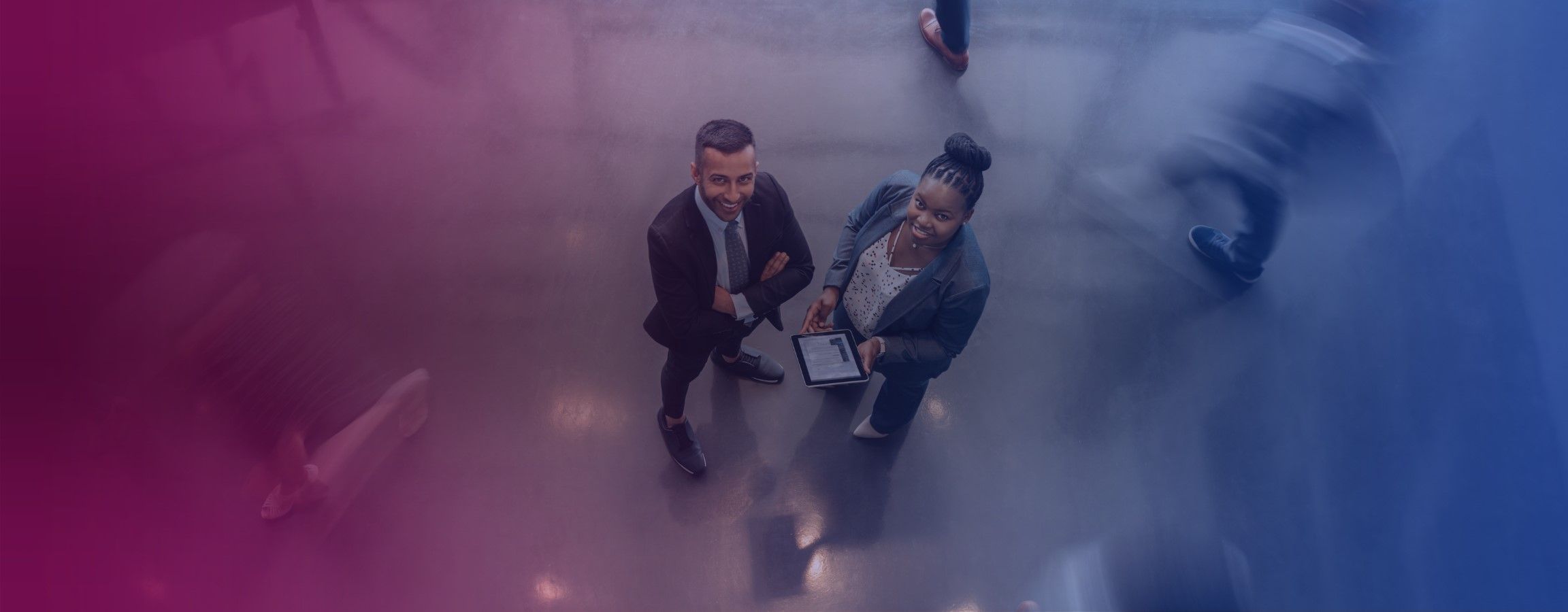Two employees looking up at the camera