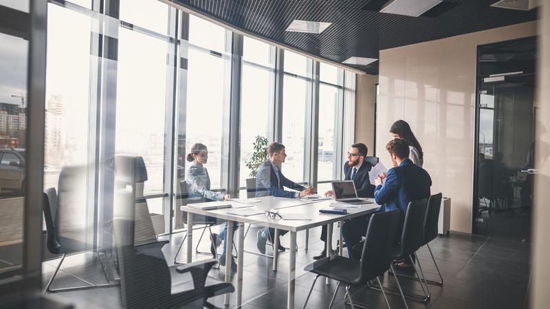 Group of people around a table having a meeting