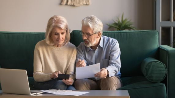 stock image of older couple working out finances