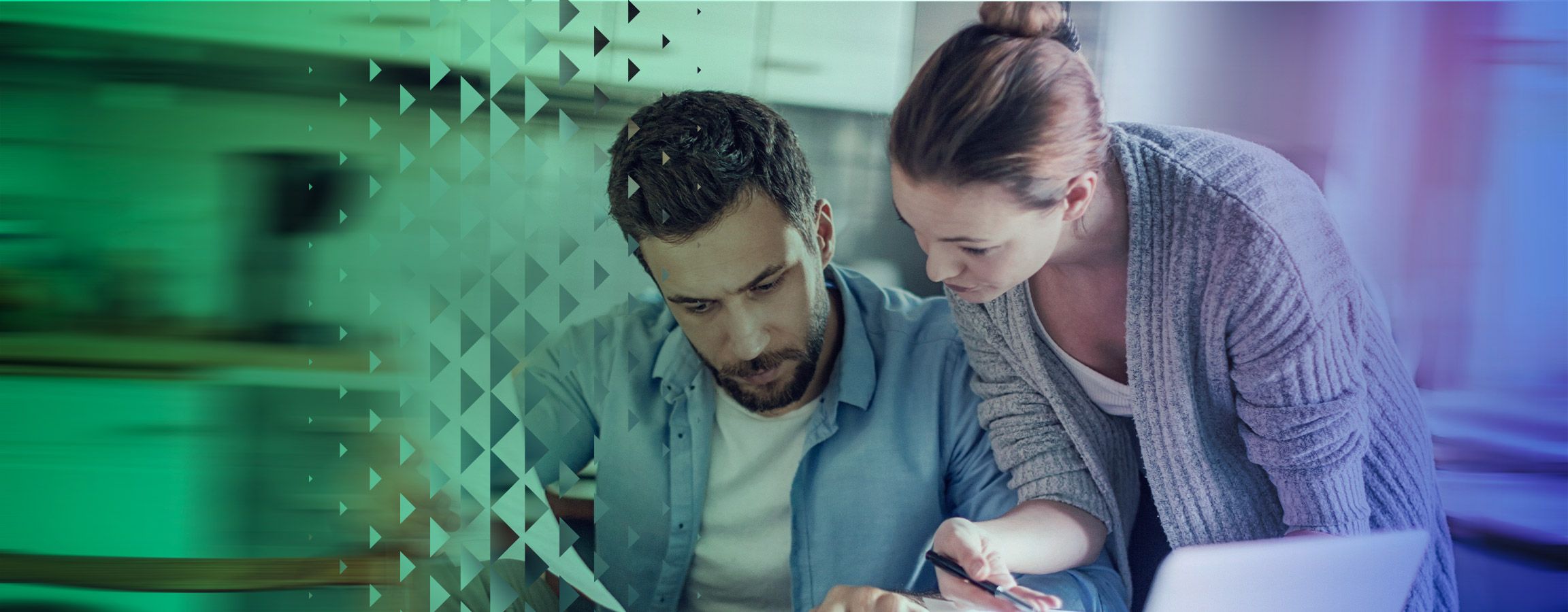 Man and woman working on a laptop