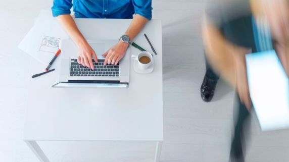 A birds eye view of an employee working at their computer
