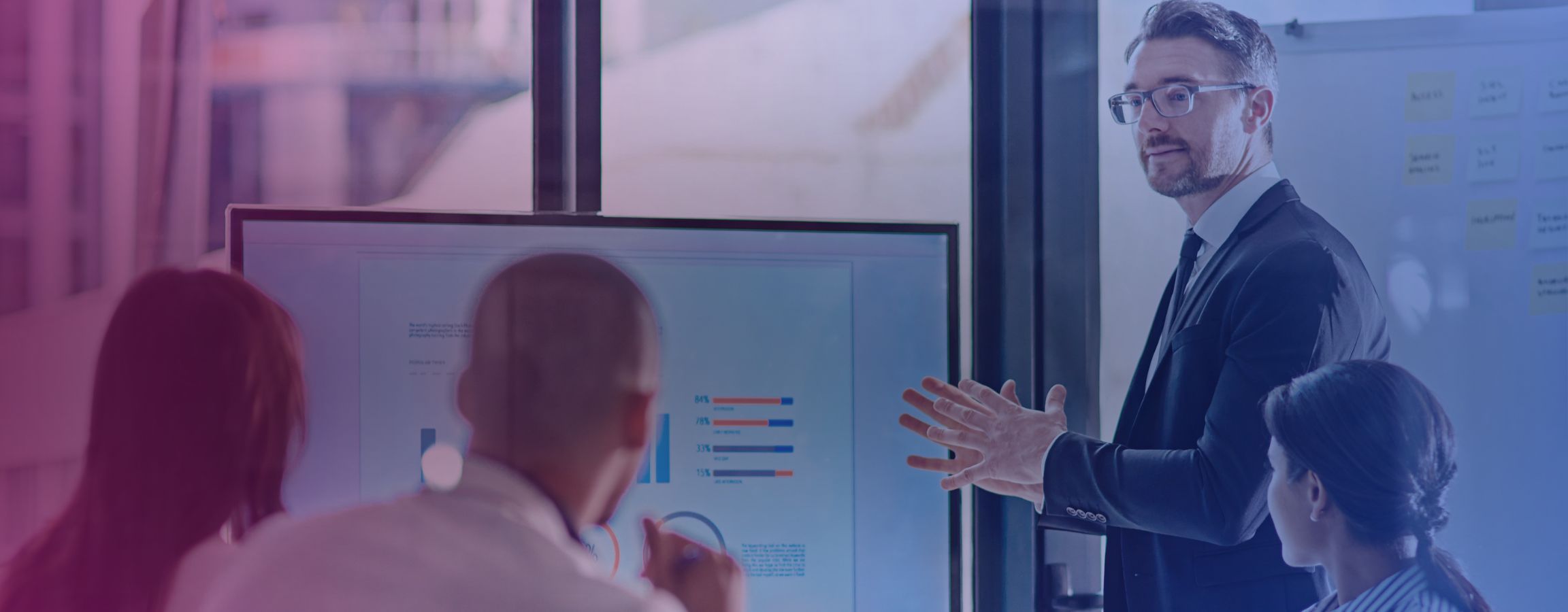 Stock image of a business meeting with an employee showing a presentation