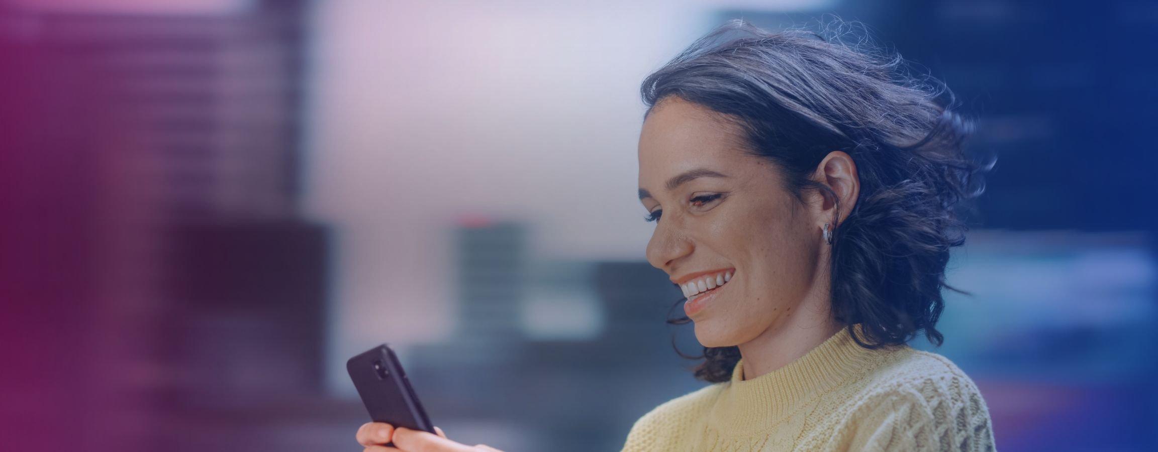 Woman smiling using a smart phone