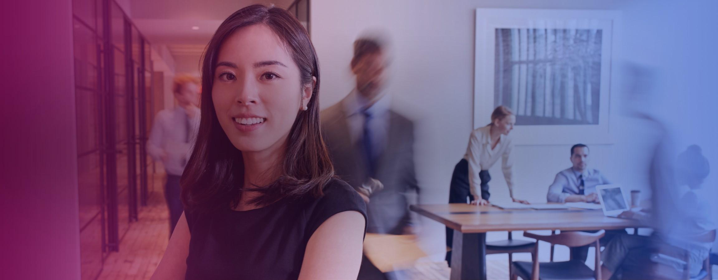 Office stock image with an employee smiling at the camera
