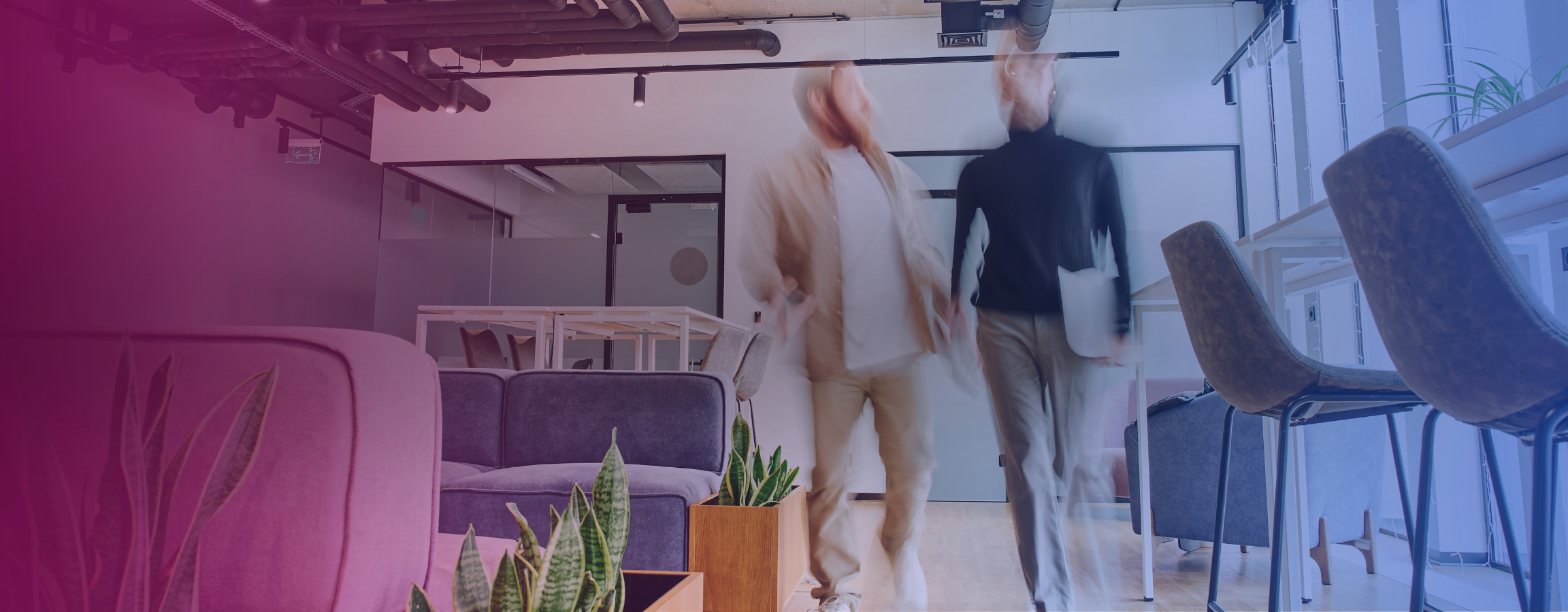 Stock image of two people walking in an office