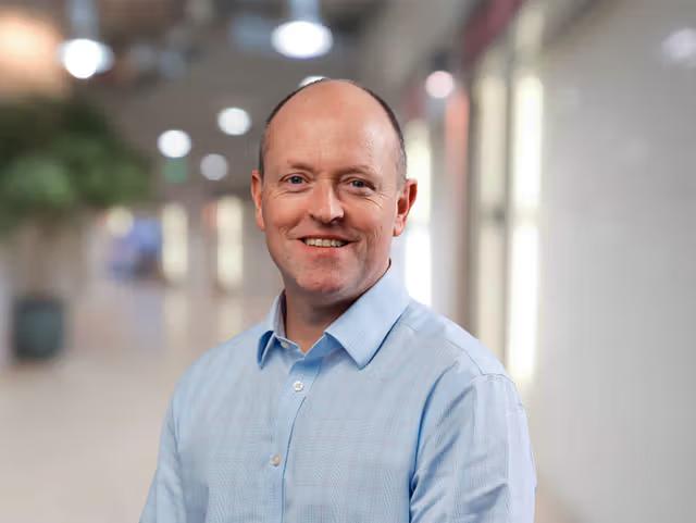 headshot of neil hughes