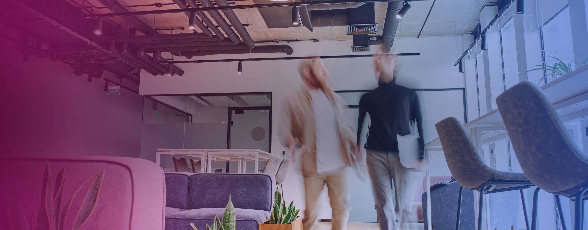 Two employees walking and talking in an office