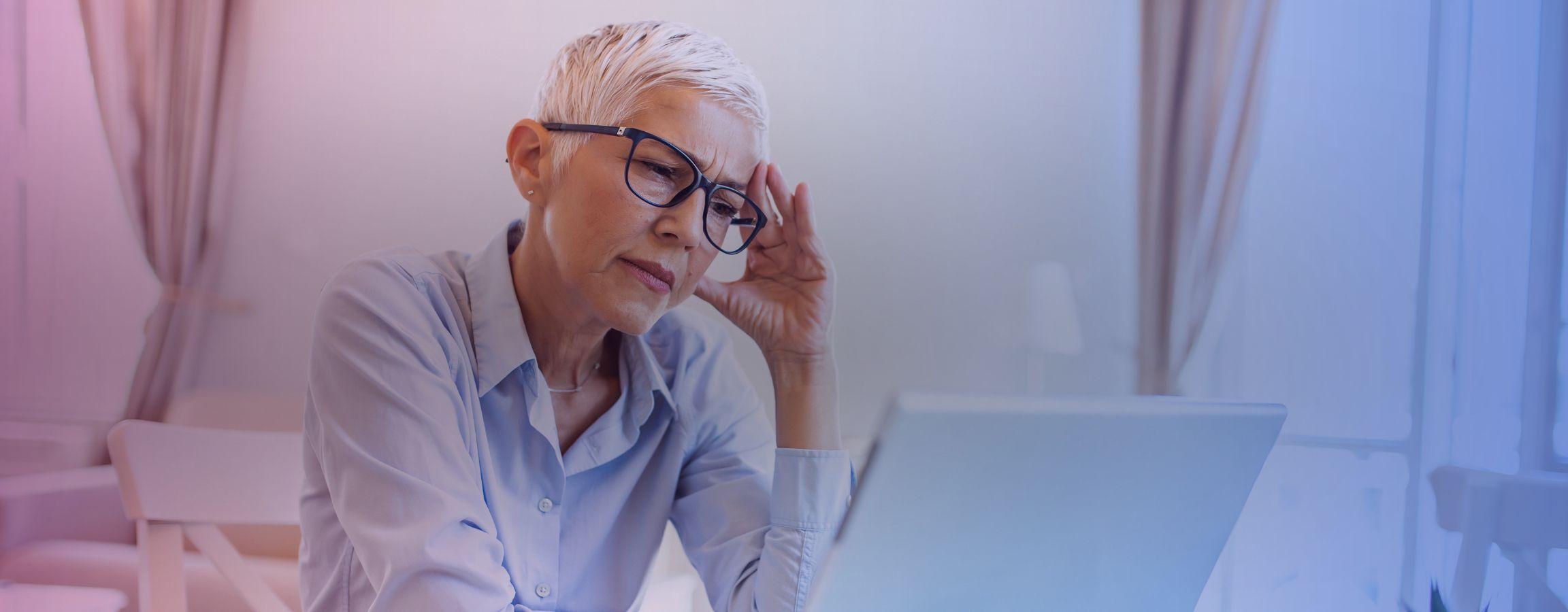 A business woman looking concerned at her laptop