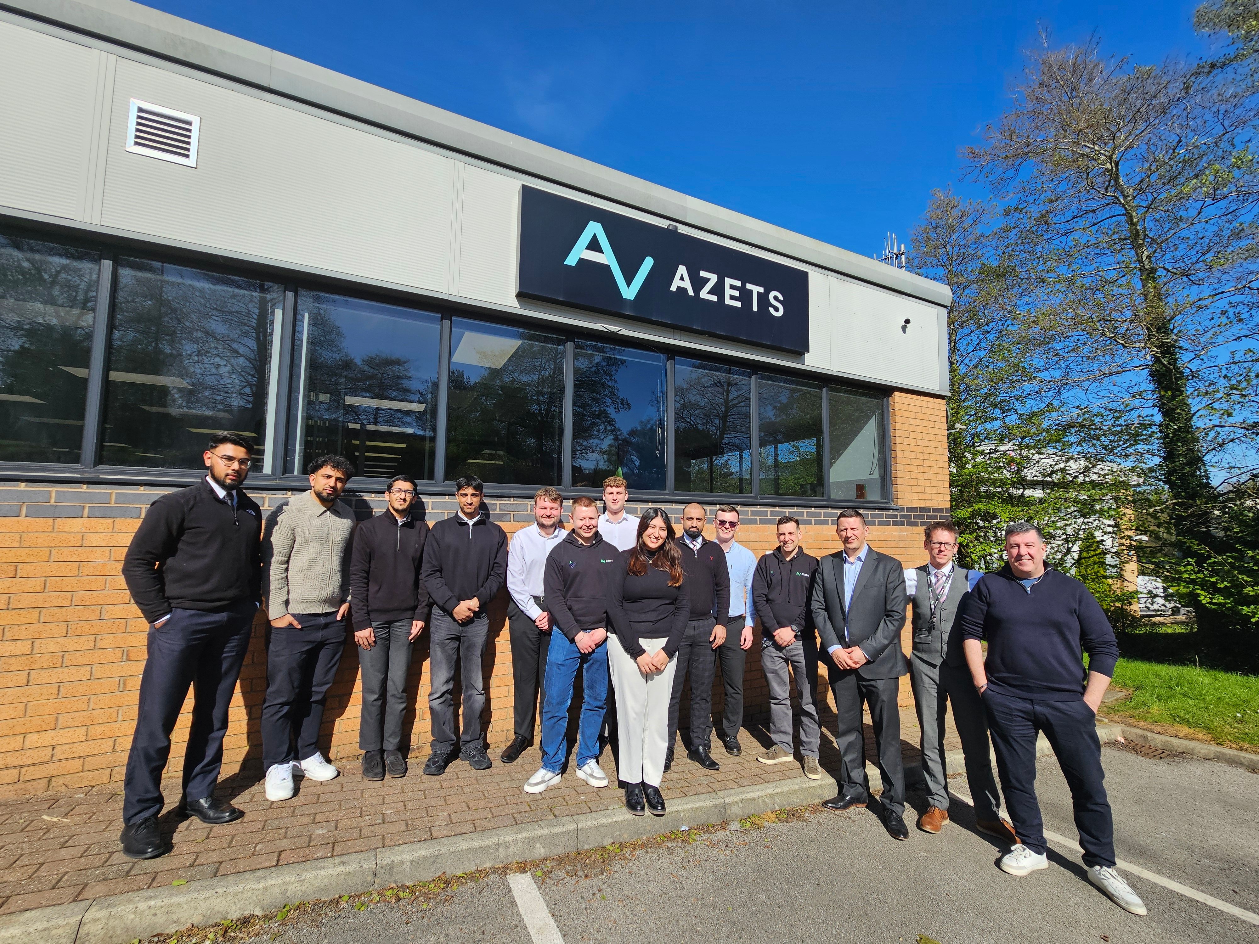 group photo of Burnley staff outside office building