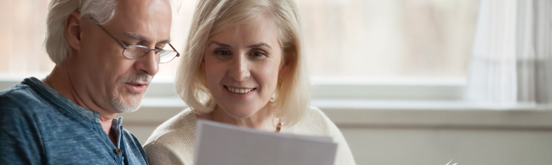 Elderly couple reading documents