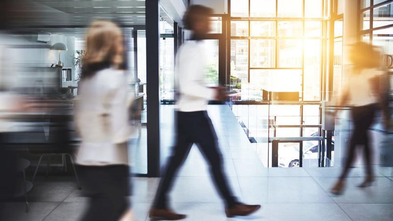 People walking through an office