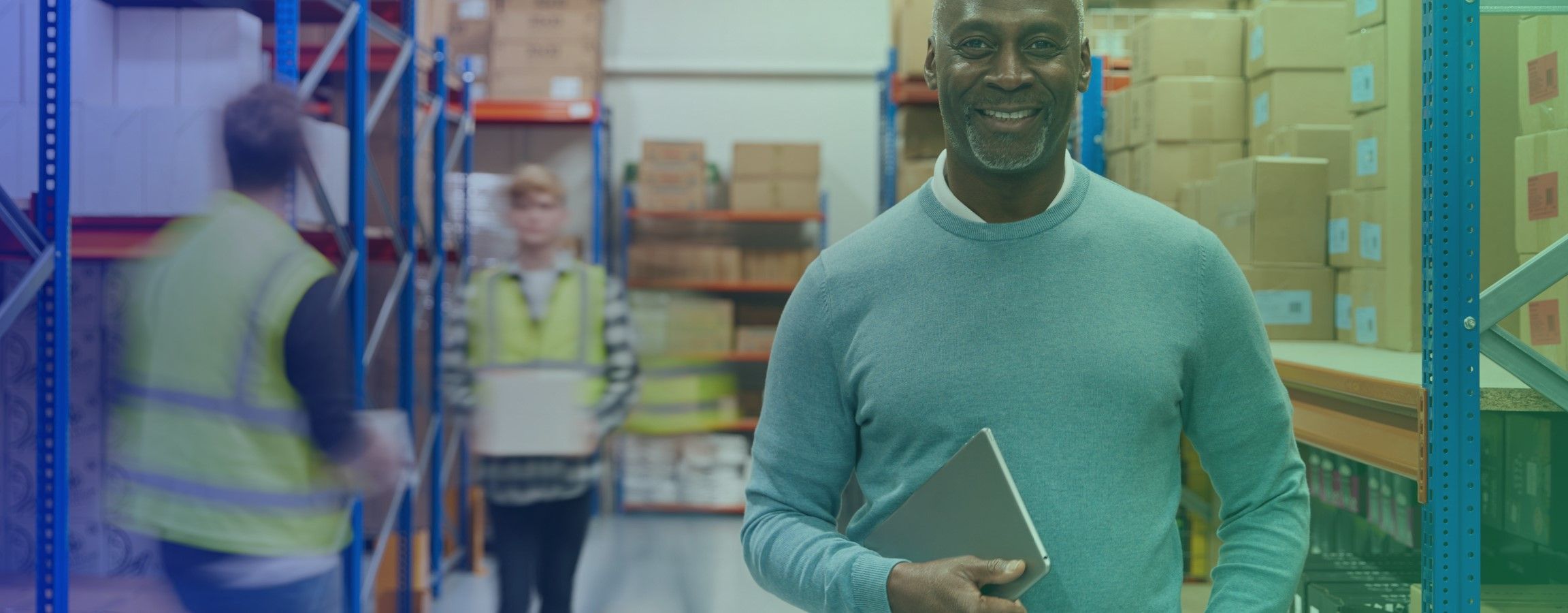 Stock image of a warehouse with a person smiling at the camera