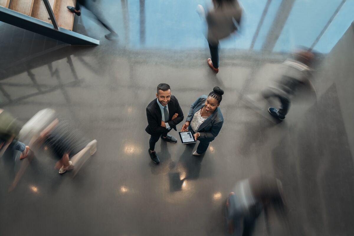 Two people looking up in a busy atrium