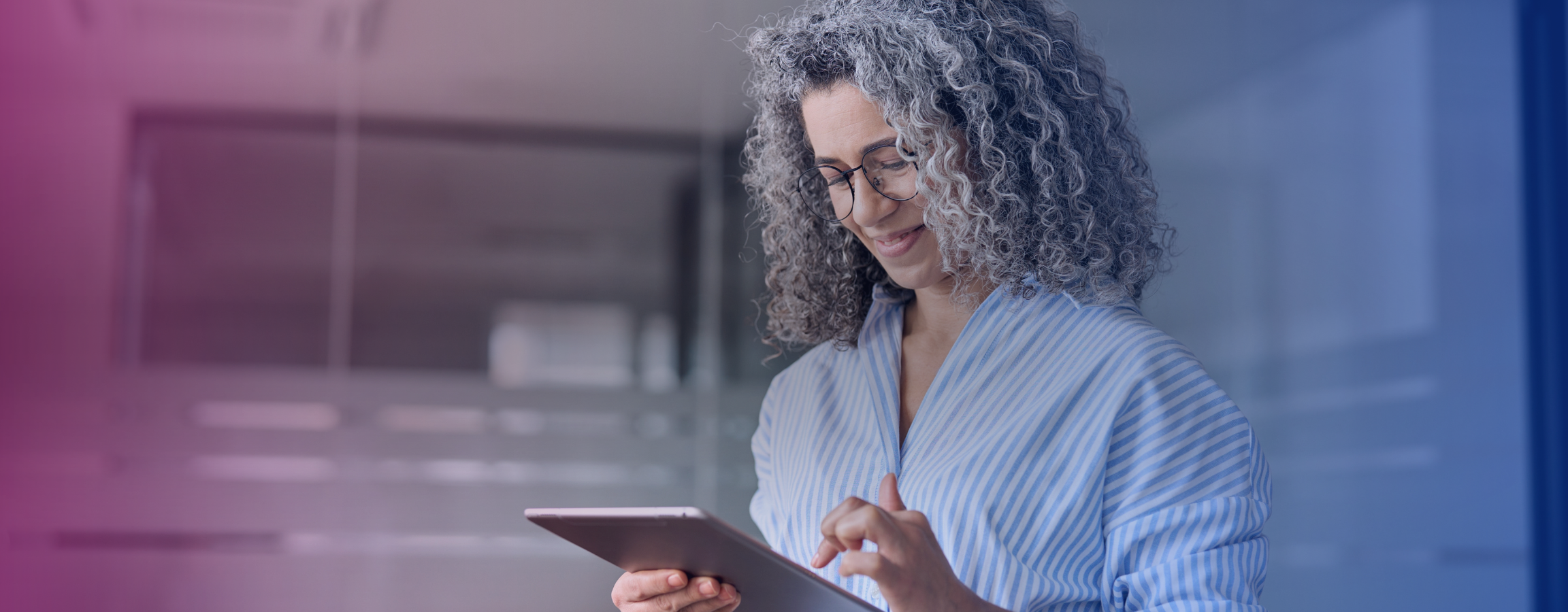 Elderly woman looking at tablet.png