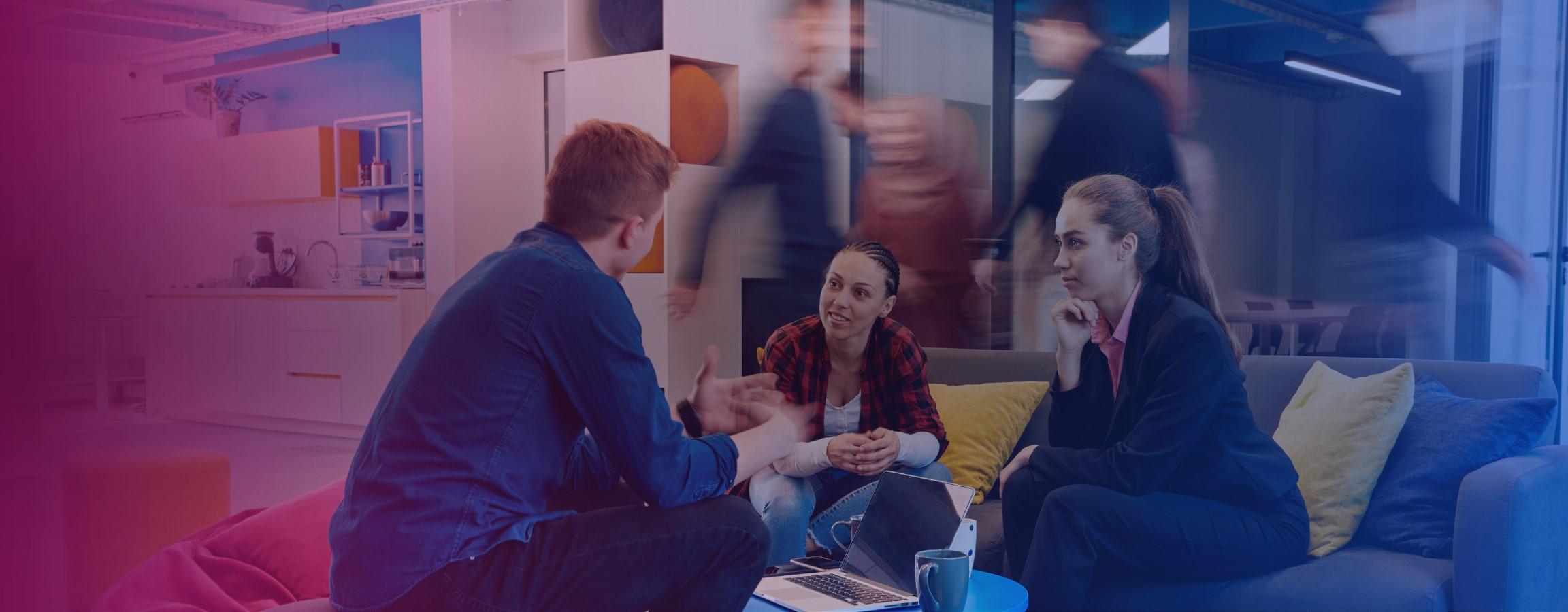 Office stock image, employees conversing at a table