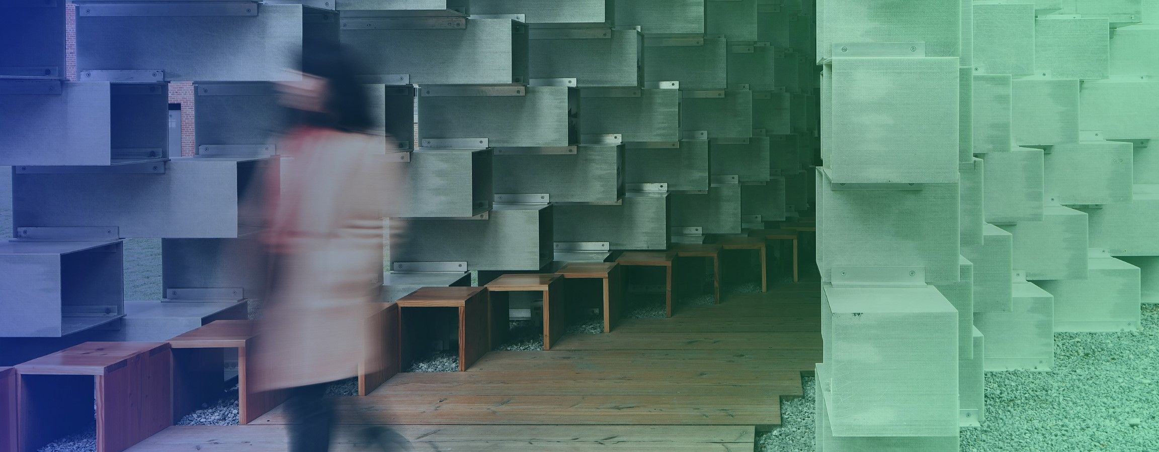 Stock image of a woman walking past a building