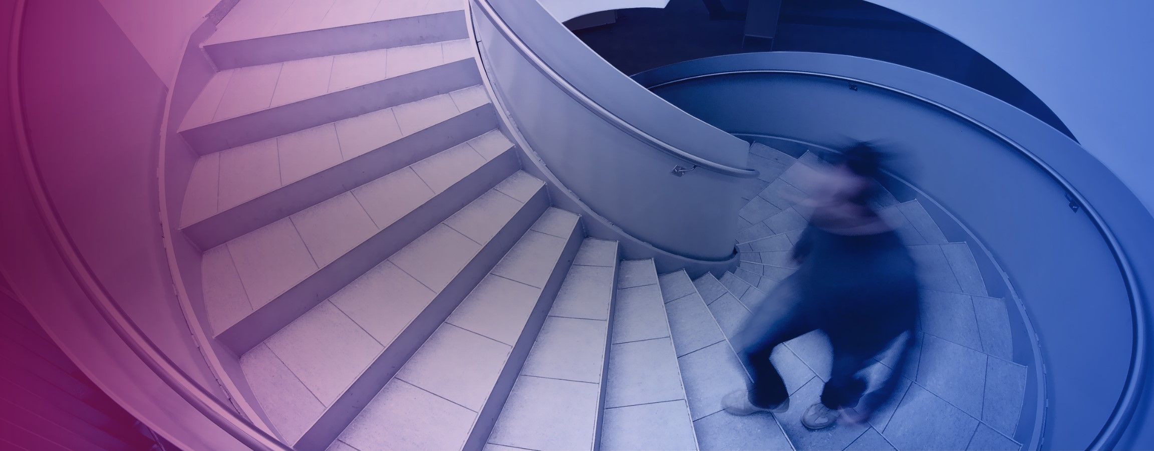 Stock image of someone walking up a spiral staircase