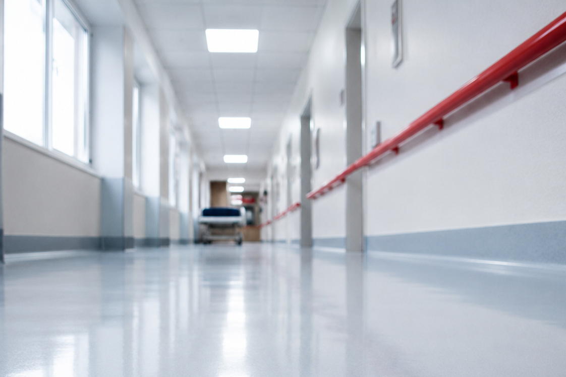 Polished vinyl floor reflecting light in a hospital corridor