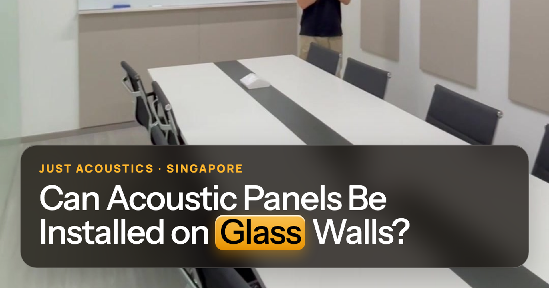 Glass-walled meeting room with panels on the solid wall