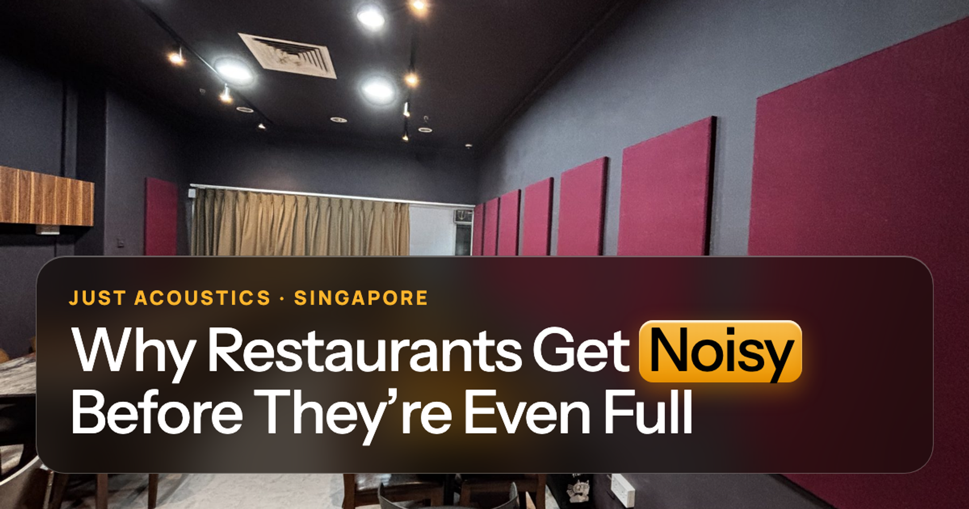 Restaurant dining room with red acoustic wall panels and wooden tables