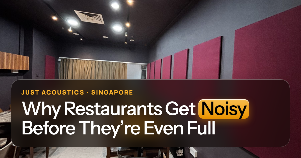 Restaurant dining room with red acoustic wall panels and wooden tables