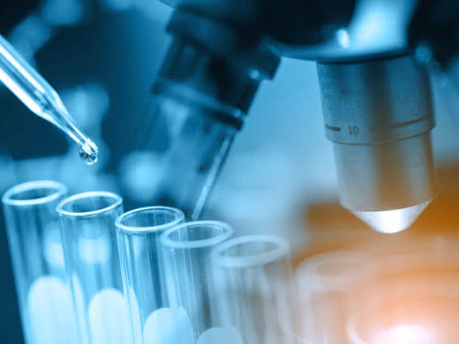 Laboratory pipette dispensing liquid into test tubes during scientific research or analysis.