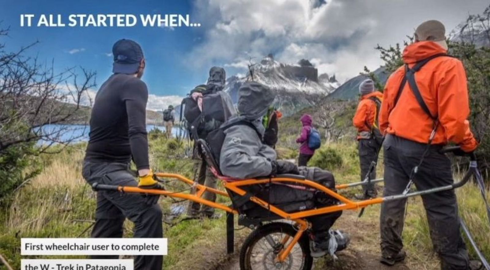 Group of hikers with a specialized yellow and orange all-terrain wheelchair on mountain trail in Patagonia.