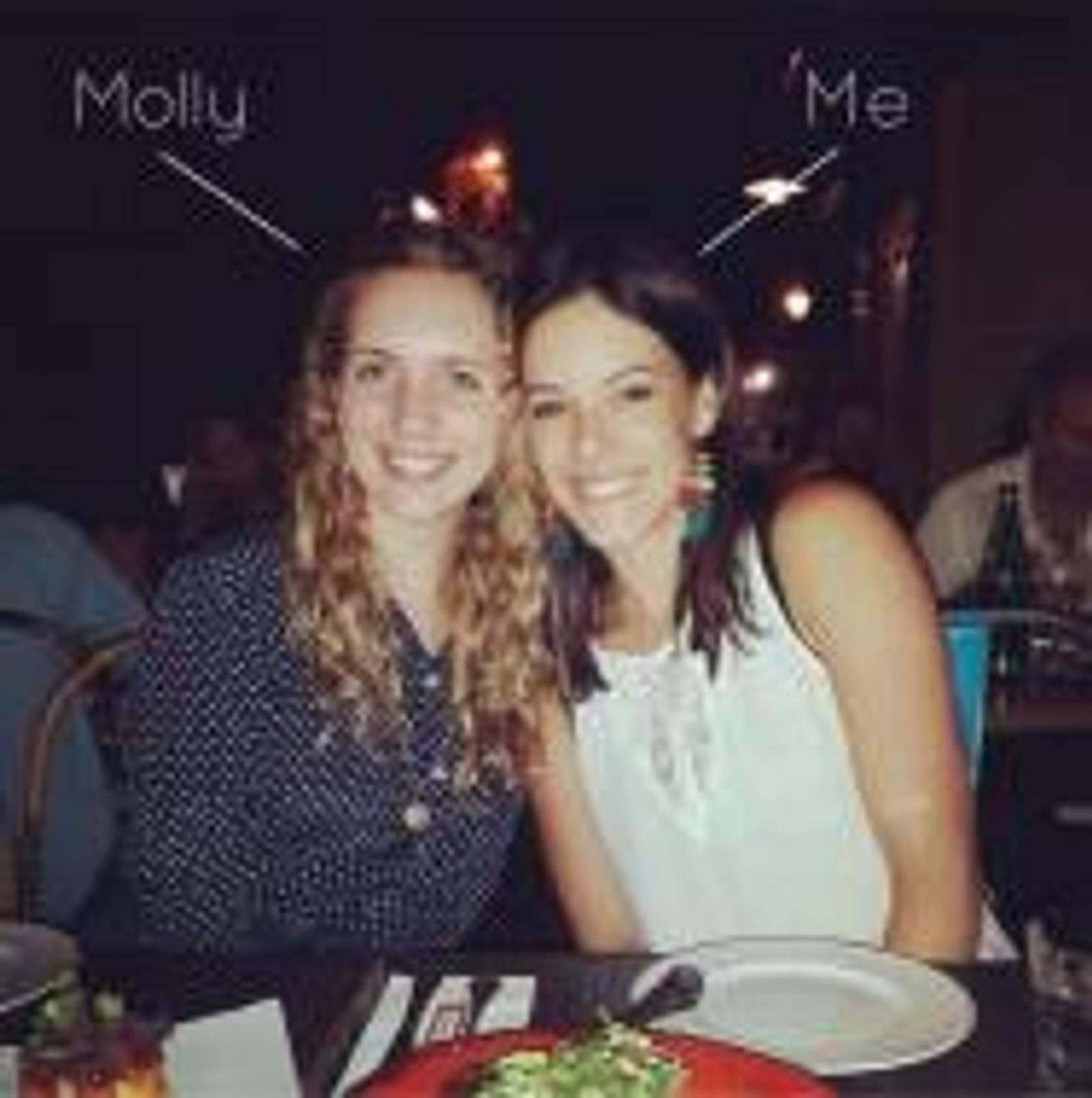 Two women smiling at dinner table with plates and decorative lights in background. Labels read "Molly" and "Me"