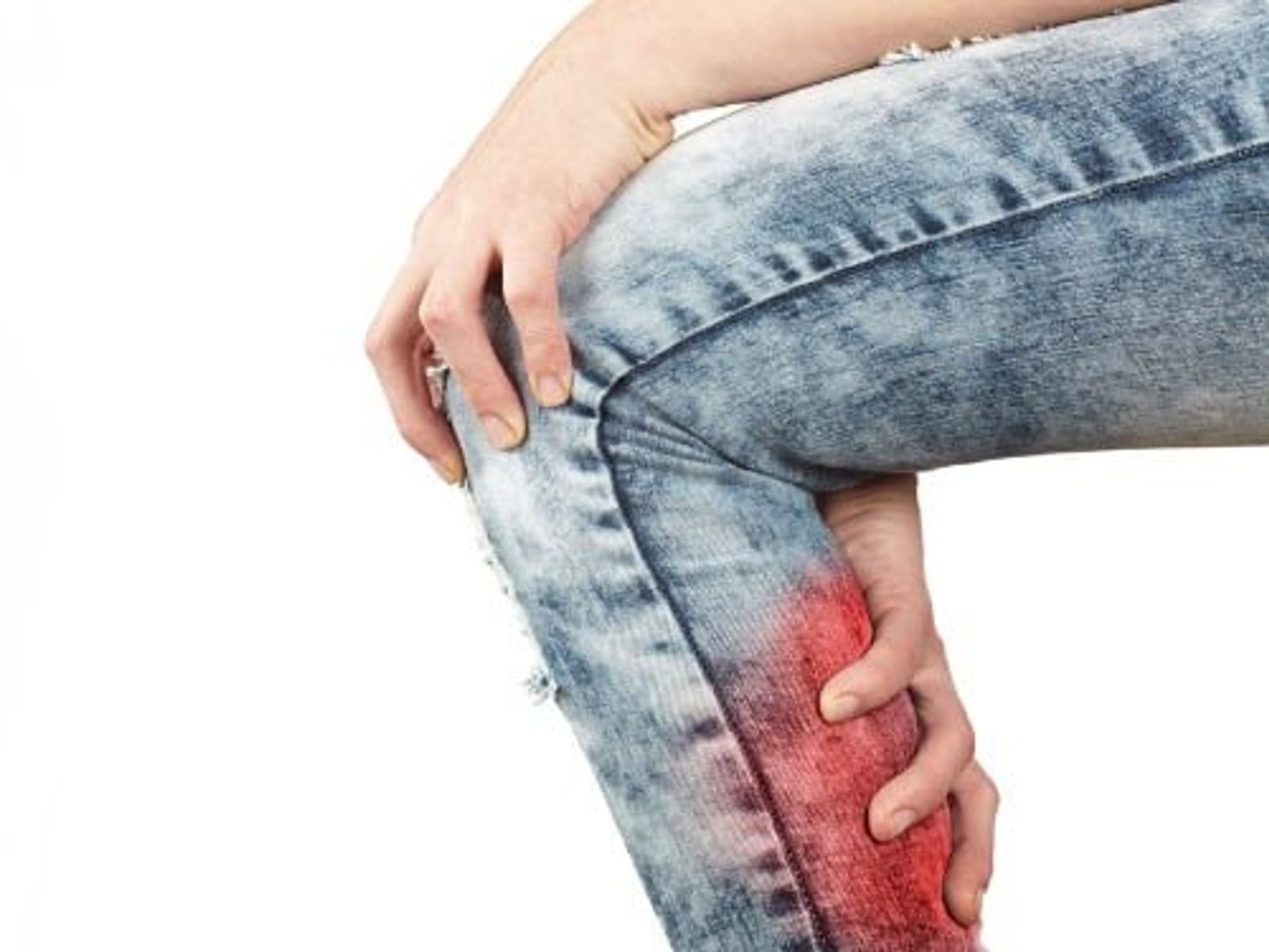 Person in jeans holding leg with red highlighted pain area on calf.