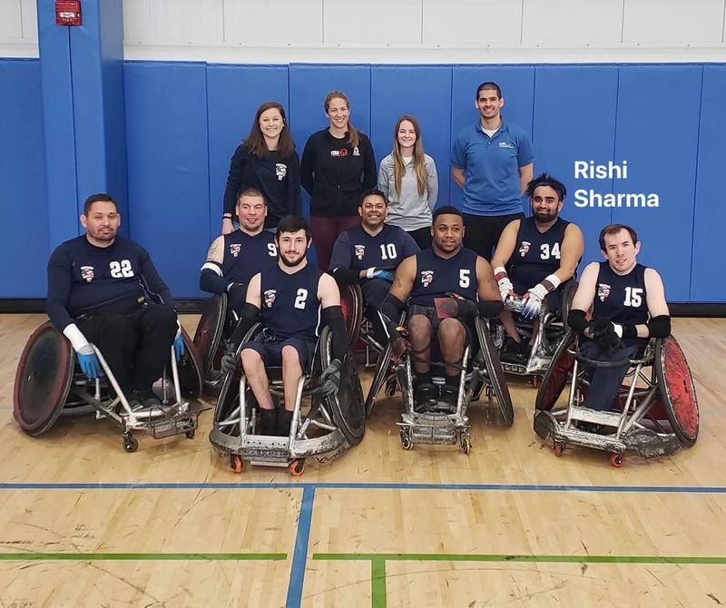 Defensive wheelchair rugby chair with an elongated pick-axe front end for stopping opponents