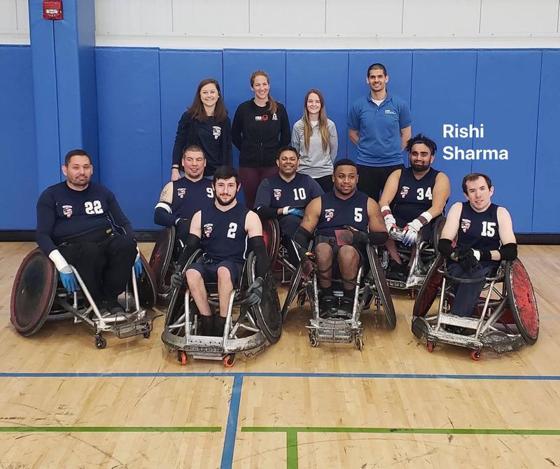 Defensive wheelchair rugby chair with an elongated pick-axe front end for stopping opponents