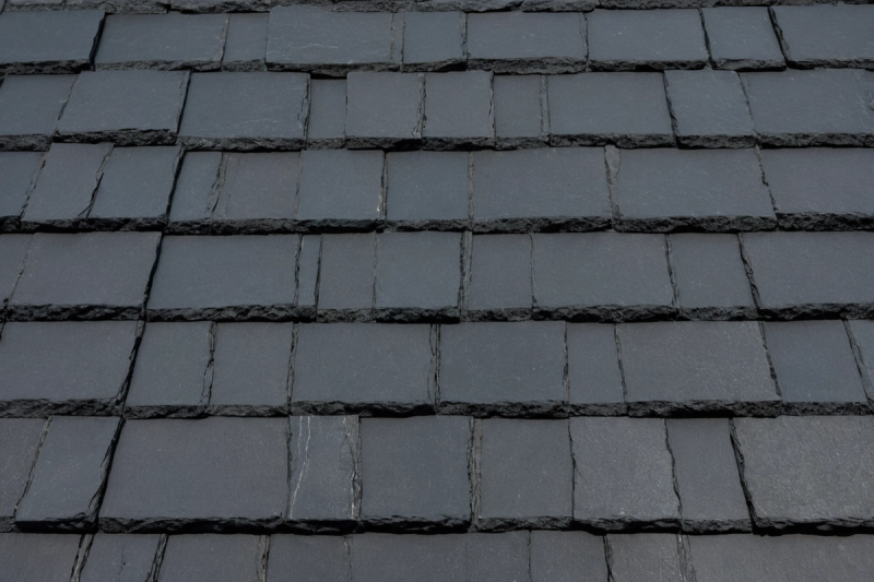 Close view of dark grey composite slate tiles laid in even courses