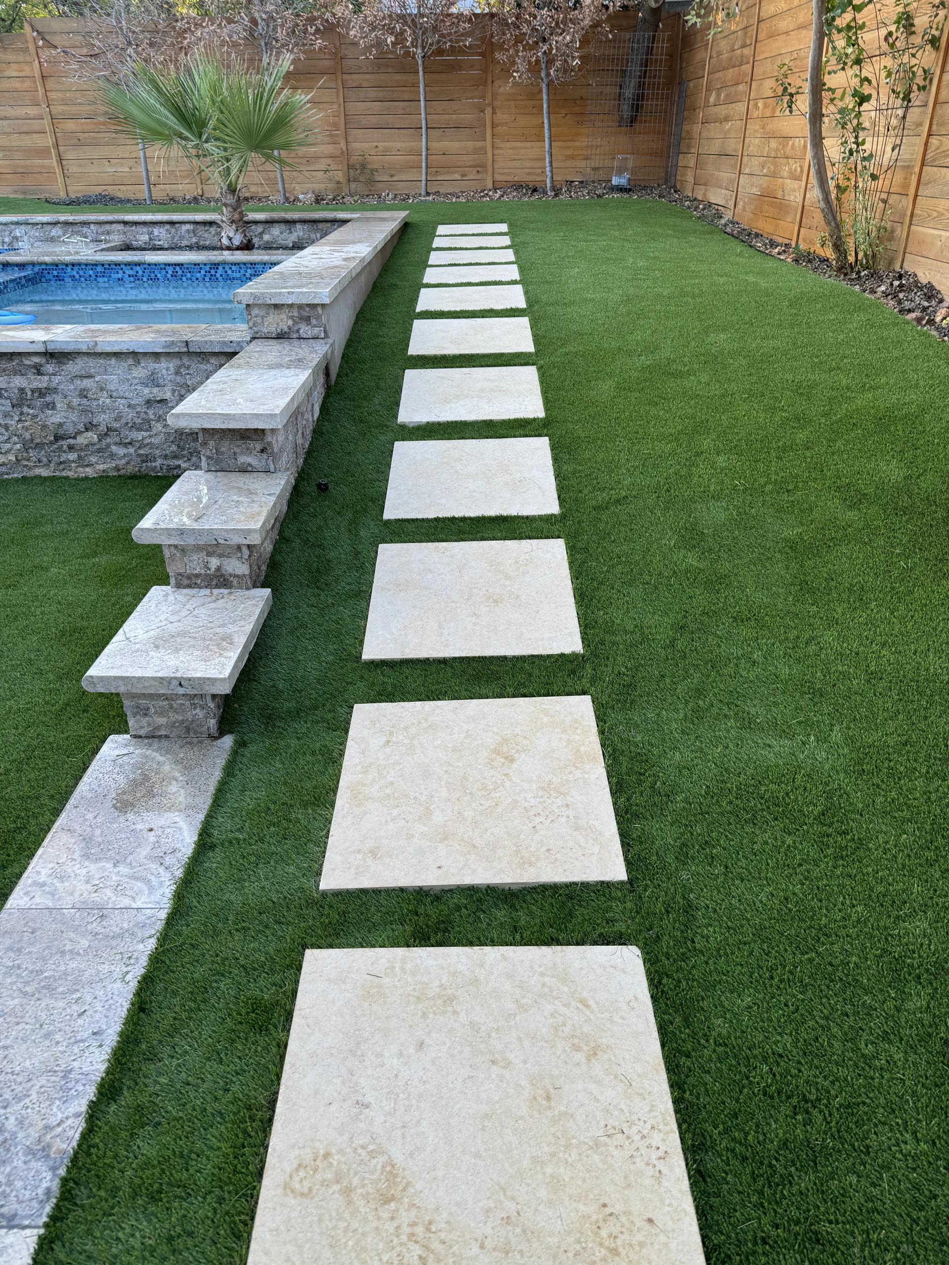 Artificial turf installation next to a fence